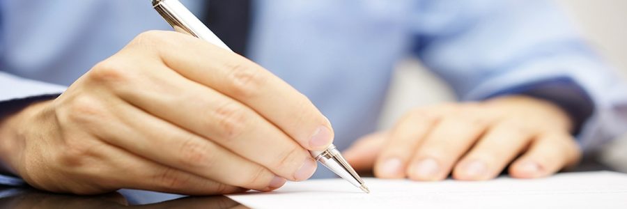 businessman is writing a letter or signing a agreement